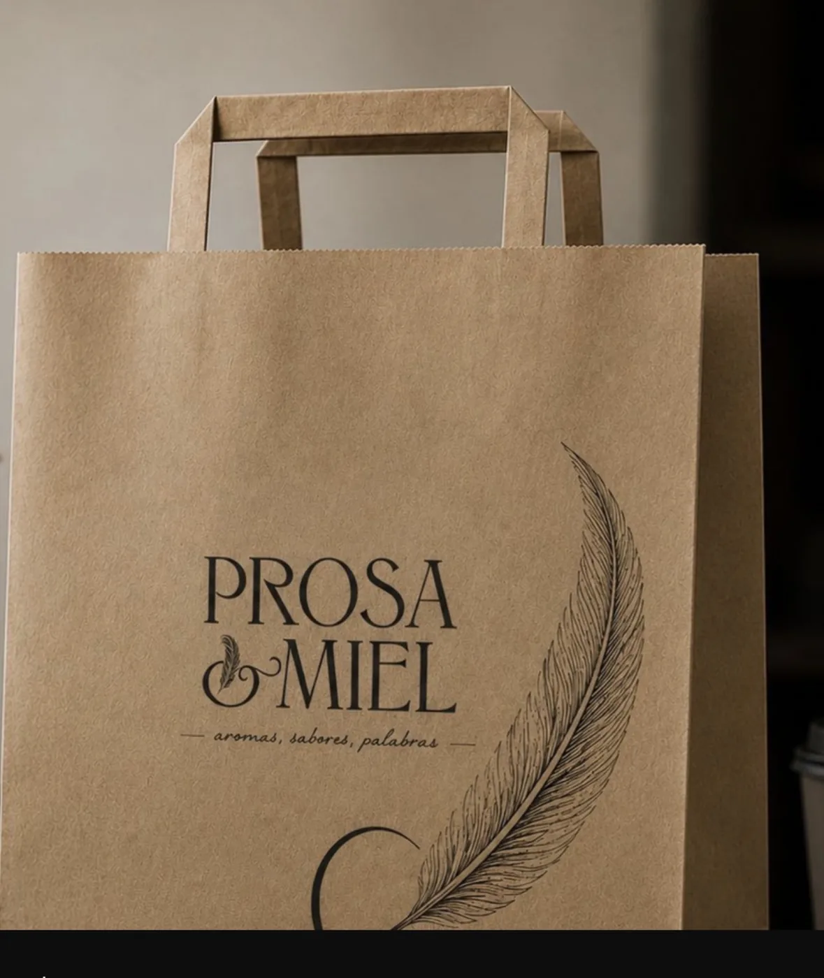 Bolsa de papel kraft con el logotipo de Prosa & Miel y una pluma dibujada.